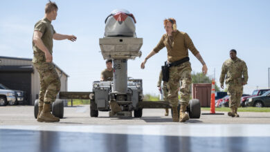 Weapons load crew members assigned to the 7th Aircraft Maintenance Unit transport an inert Joint Air-to-Surface Standoff Missile to a B-1B Lancer during a Load of the Quarter competition at Dyess Air Force Base, Texas, April 14, 2022. A JASSM is a conventional long-range standoff munition that offers weapons system officers the capability to engage various targets. (U.S. Air Force photo by Senior Airman Colin Hollowell)
