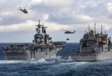 ATLANTIC OCEAN (April 25, 2022) HM-60 Seahawks attached to Helicopter Squadron Command 26 and Helicopter Squadron Command 22 fly packages from the Lewis and Clark-class dry cargo ship USNS Robert E. Peary (T-AKE-5), right, to the third Wasp-class amphibious assault ship USS Kearsarge (LHD-3), during a vertical replenishment, April 25, 2022. Gunston Hall, assigned to the Kearsarge Amphibious Ready Group, is on a scheduled deployment under the command and control of Task Force 61/2 while operating in U.S. sixth Fleet in support of U.S., Allied and partner interests in Europe and Africa. (U.S. Navy Photo by Mass Communication Specialist Seaman Keith Nowak)