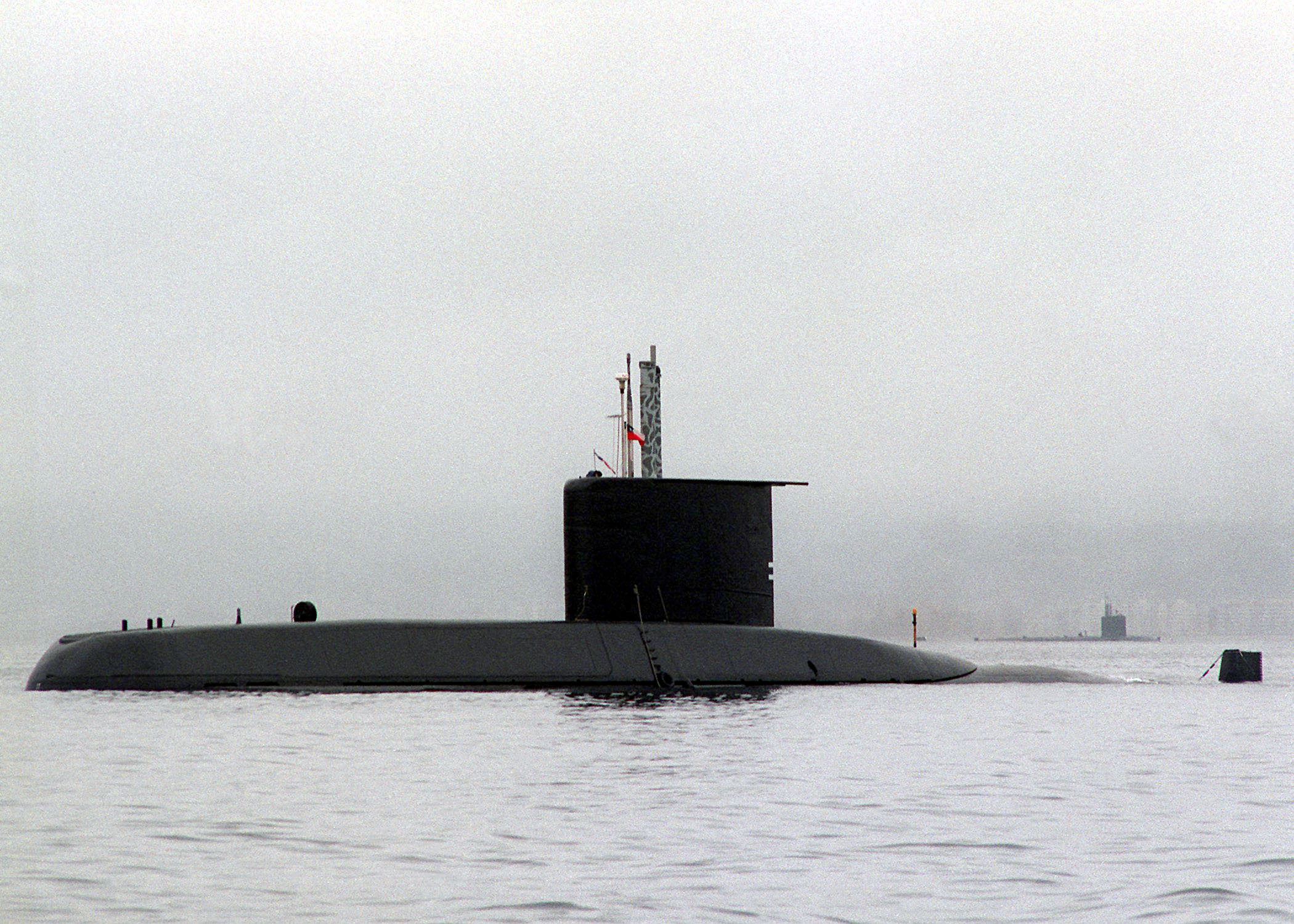 The Chilean Navy THOMSPON (Type 209) CLASS (TYPE 1300) (SSK) submarine anchored at Coquimbo, Chile. The U.S. Navy WARWHAL CLASS (SSN) nuclear-powered submarine USS Narwhal (SSN 671) is anchored in the background. Both submarines are participating in Phase 5 exercises of OPERATION UNITAS 37-96.