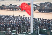 The Chinese flag is raised during a military parade at the Zhurihe training base