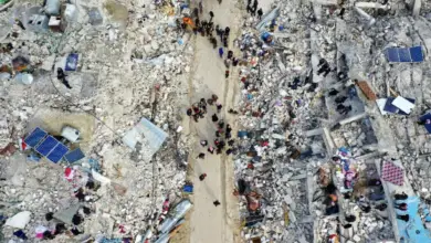 This aerial view shows residents searching for victims and survivors amidst the rubble of collapsed buildings following an earthquake in the village of Besnia near the twon of Harim, in Syria's rebel-held northhwestern Idlib