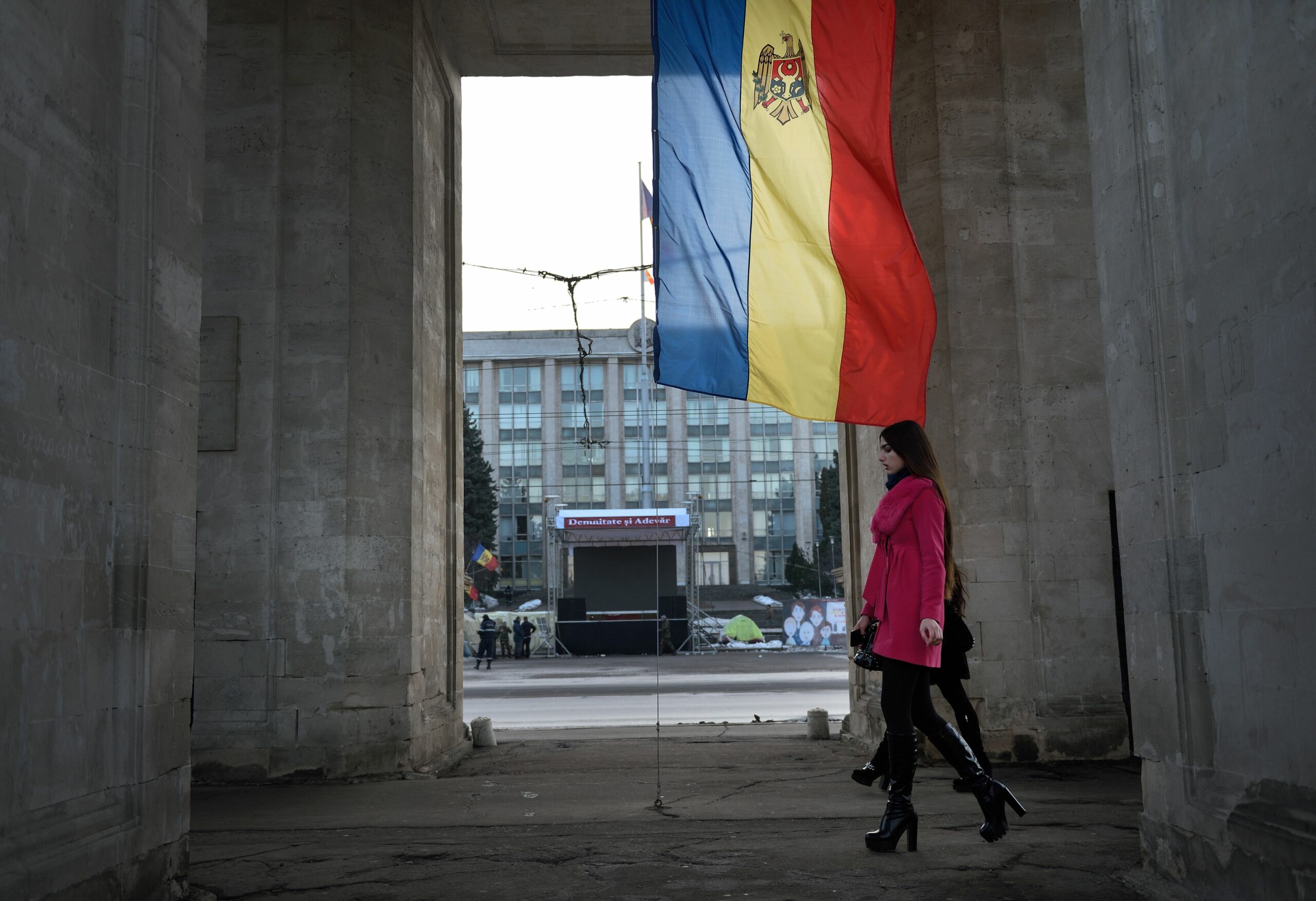People walk under the Triumph Arch in Chisinau, Moldova.