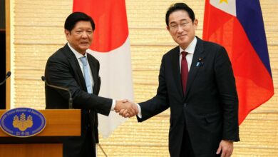 Japanese Prime Minister Fumio Kishida shakes hands with Philippine President Ferdinand Marcos during a press conference