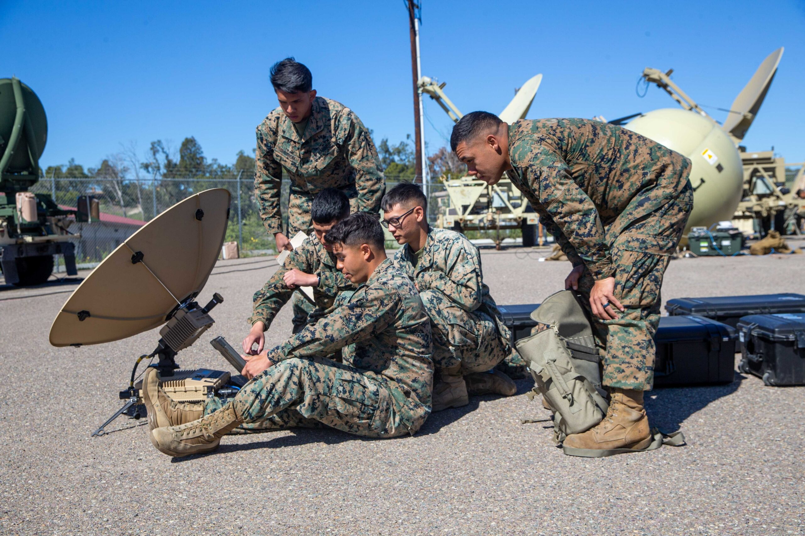 U.S. Marines with 9th Communication Battalion, I Marine Expeditionary Force Information Group, troubleshoot the Marine Corps Wideband Satellite Communications - Expeditionary at Marine Corps Base Camp Pendleton, California, March 11, 2022. This training allows the 9th Communication Battalion to be capable of operating, defending, and preserving information networks to enable command and control for the commander in all domains, and support and conduct Marine Air Ground Task Force operations in the information environment. (U.S. Marine Corps photo by Cpl. Alize Sotelo