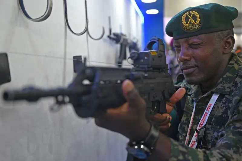 An African soldier checks a weapon at the weapon display session during Africa-India field training exercise (AFINDEX-2023), in Pune on March 29, 2023