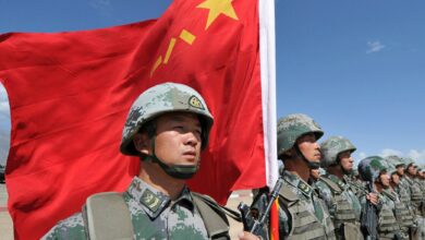 A Chinese soldier holding a flag during military exercises