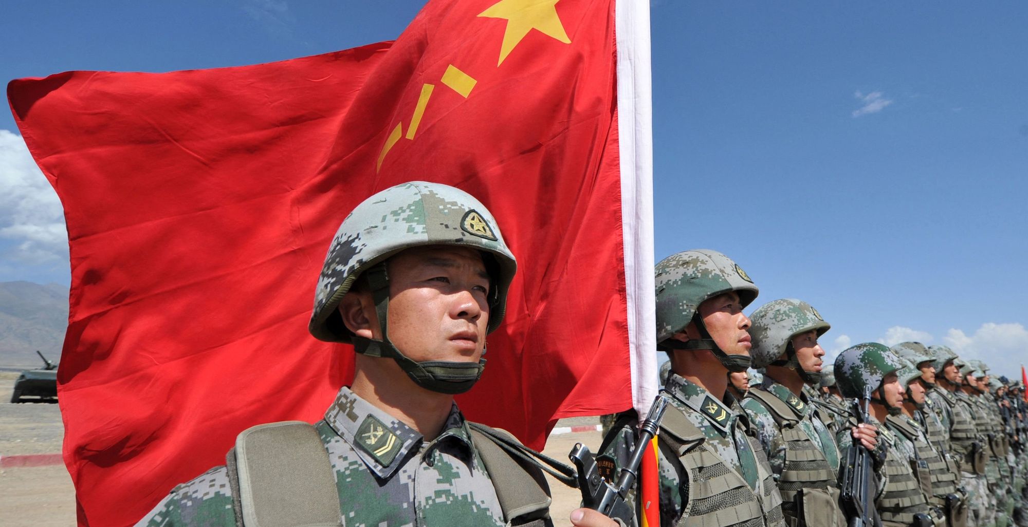 A Chinese soldier holding a flag during military exercises