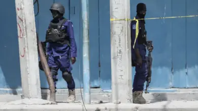 Security officers patrol at the the site of explosions in Mogadishu
