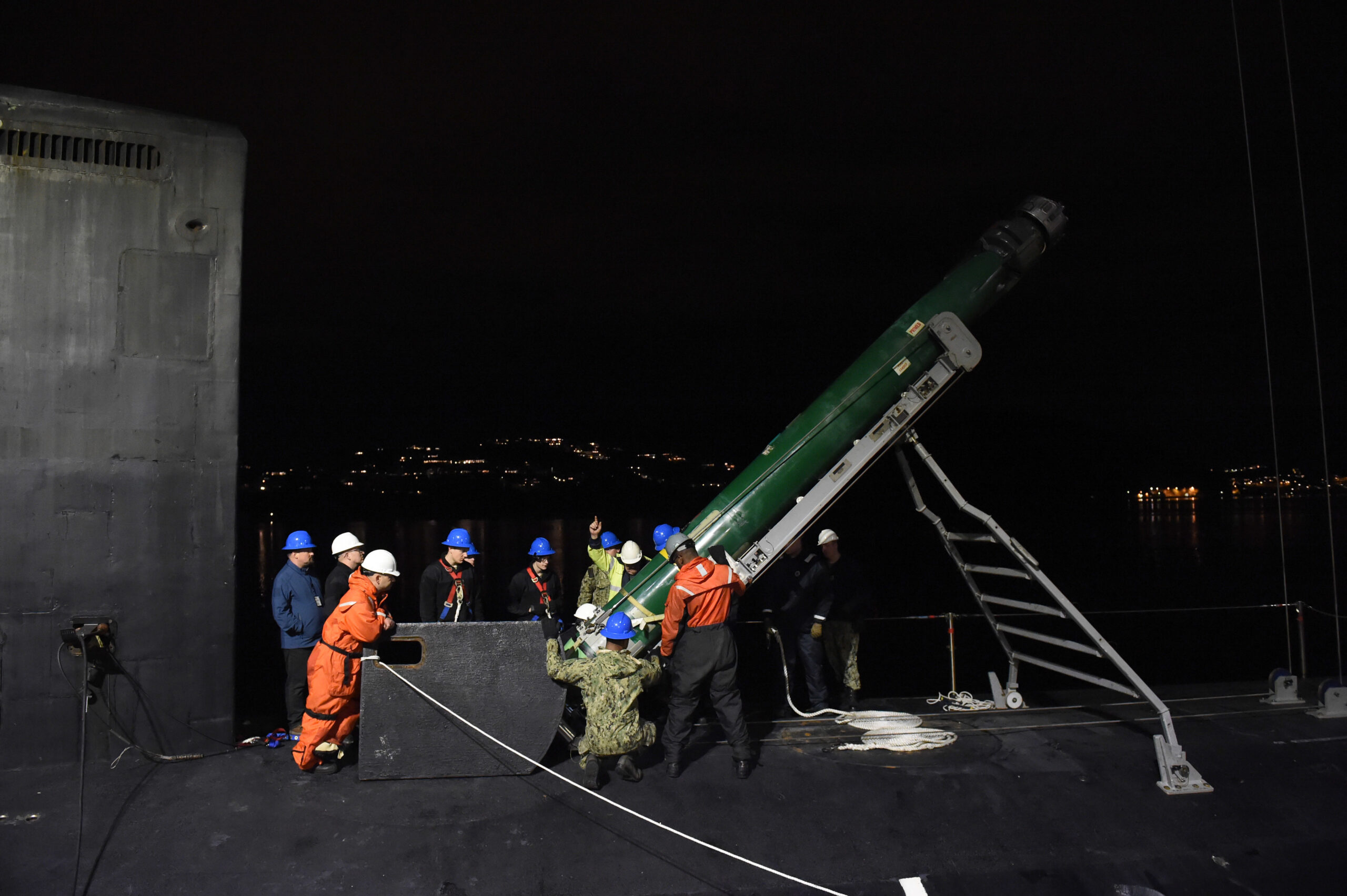 191018-N-UN744-1259 - HAAKONSVERN NAVAL BASE, Norway (Oct. 18, 2019) - Sailors assigned to the Virginia-class, nuclear-powered, fast-attack submarine USS Minnesota (SSN 783) work alongside Norwegian crane operators to guide an MK-48 Advanced Capability torpedo into the submarine during an ordnance onload at the Haakonsvern Naval Base in Bergen, Norway, Oct. 18, 2019. Minnesota, the 10th ship of the Virginia class, is on a regularly scheduled deployment in the U.S. 6th Fleet area of operations in support of U.S. national security interests in Europe and Africa. (U.S. Navy photo by Chief Mass Communication Specialist Travis Simmons)