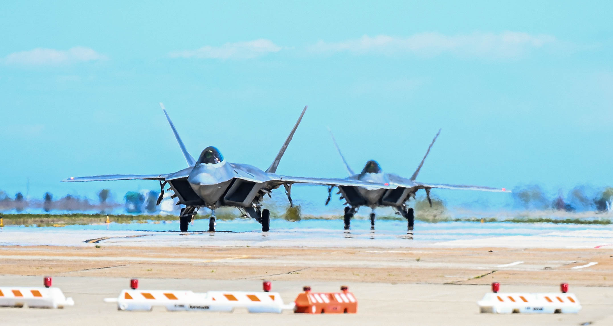 The first two F-22 Raptors, part of the incoming Formal Training Unit aircraft fleet, touch down at Joint Base Langley-Eustis, Virginia, Mar. 29, 2023. JBLE has been working hard over the last four years to prepare for the bed down of 30 additional F-22 Raptors and the establishment of the FTU. (U.S. Air Force photo by Airman 1st Class Mikaela Smith)