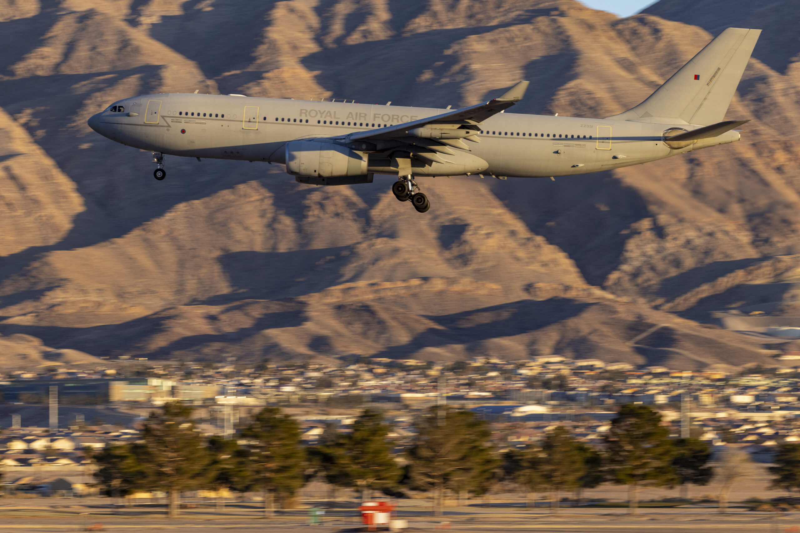 Image shows a. RAF Voyager from RAF Brize Norton landing at Nellis Air Force Base during Red Flag 23-1. A Royal Air Force detachment, operating from Nellis Air Base Nevada, is honing its cutting-edge air combat skills in the largest scale Exercise Red Flag to date. Exercise Red Flag is the pre-eminent annual air combat training exercise run by the United States. The United States Air Force has expanded this long-established exercise to include a vastly increased geographical area to challenge participants to overcome what USAF planners are calling the Tyranny of Distance in addition to the traditional combat air missions of previous exercises. The Exercise has previously been run over the Nevada Test and Training Range and area of 12,000 square miles of airspace and 2.9 million acres of land. Now training areas in Utah and California have been added, as well as missions being flow out over the Californian Pacific Coast. The exercise area has therefore become vast and is aimed to reflect the challenges of conducting air operations at range The RAF detachment of around 300 personnel currently taking part on the exercise is operating seven Typhoons from RAF Lossiemouth based II (Army Co-operation) Squadron, plus a Voyager operated from 10 and 101 Squadron based at RAF Brize Norton. In addition, aircrew from 51 Squadron based at RAF Waddington have been integrated into the flight crew of a USAF RC-135 Rivet Joint intelligence gathering aircraft. Australia is the only other nation participating, reflecting the close Defence partnership between our three countries.