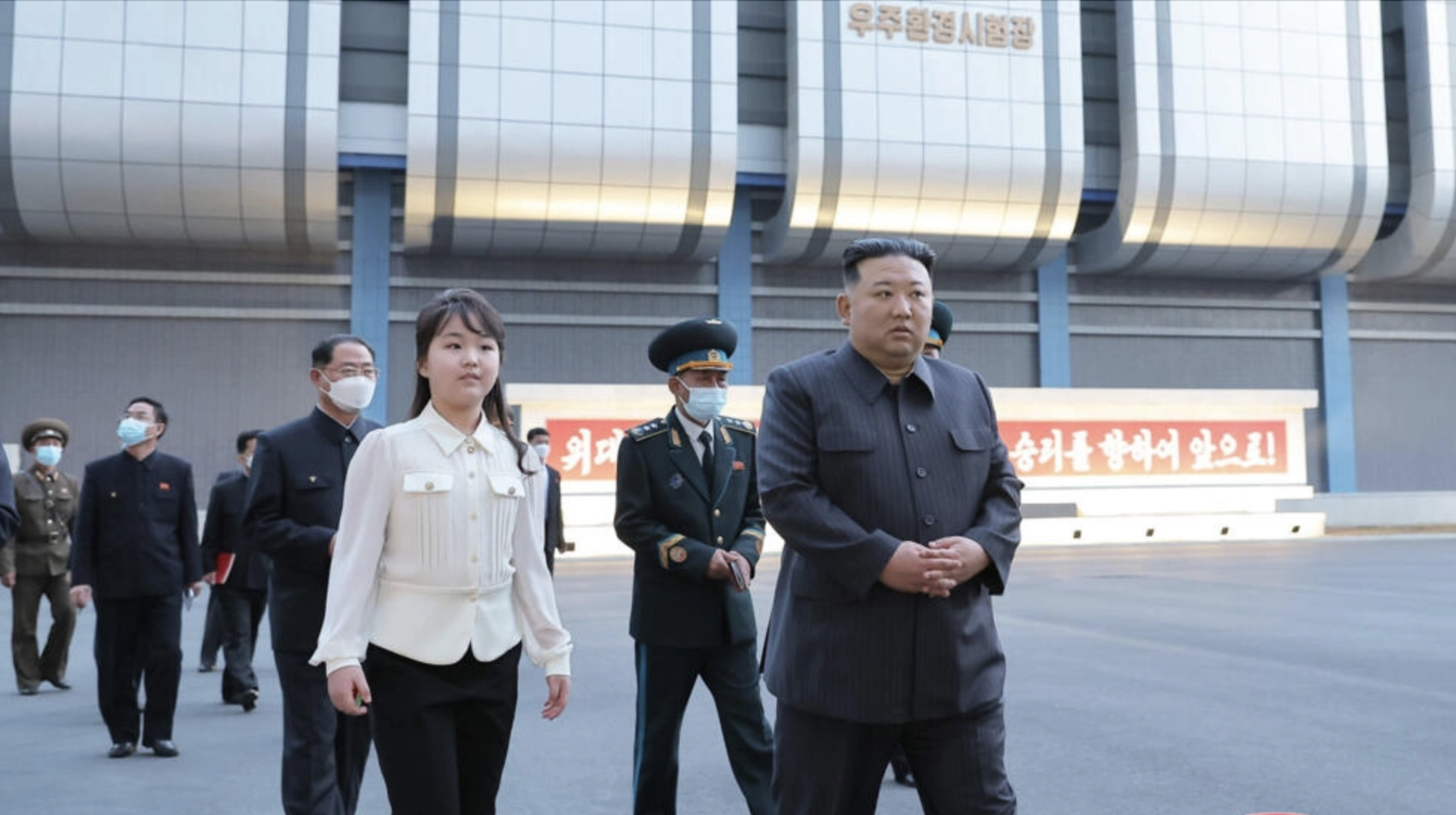 North Korean leader Kim Jong Un (R) has ordered the launch of the country's first spy satellite