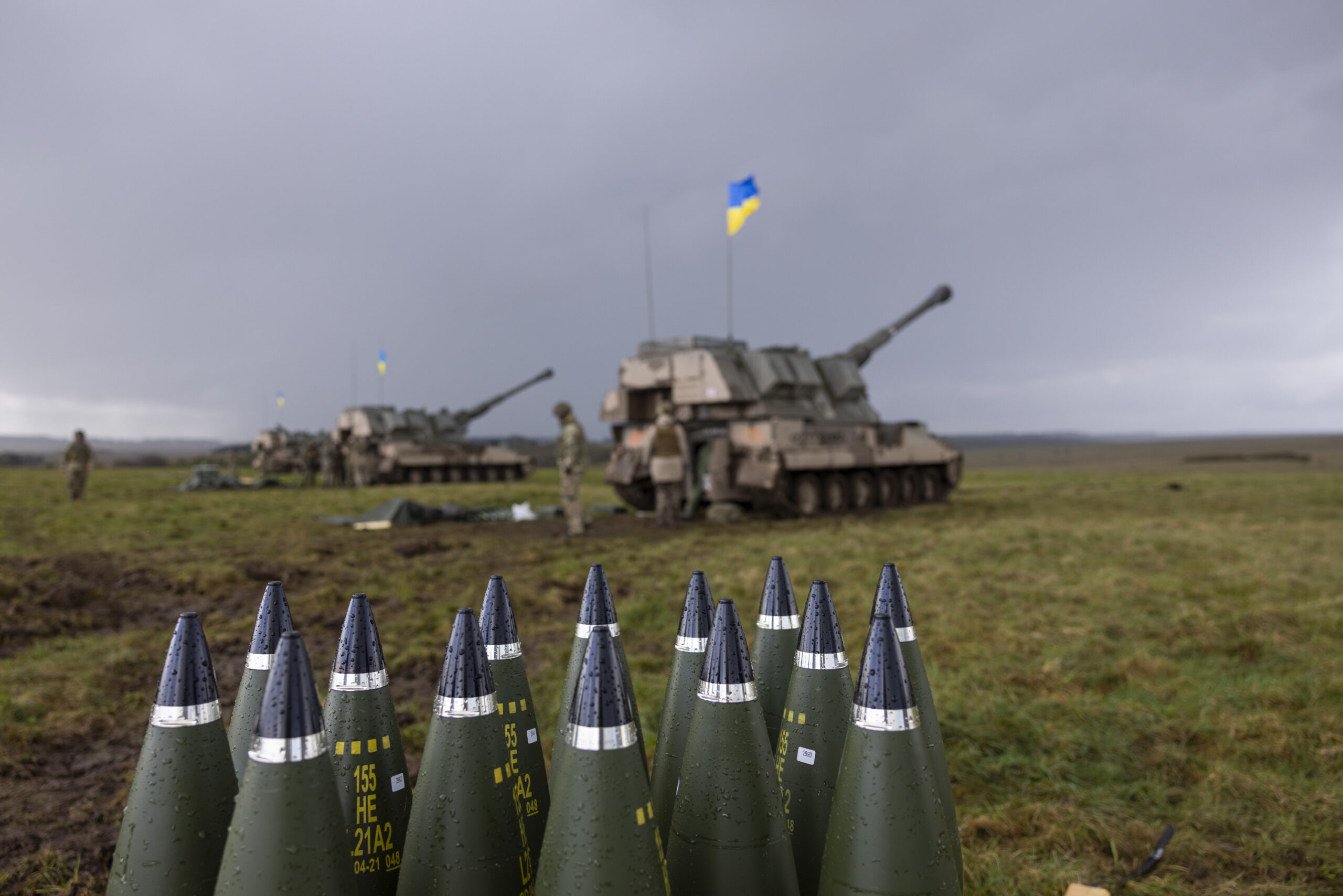 155mm artillery rounds stacked up behind the line of AS90s and their Ukrainian operators. Photographer: Corporal Rob Kane ©MoD Crown Copyright 2022
