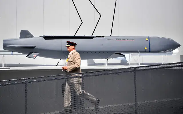 A member of the military walks past an MBDA Storm Shadow/Scalp missile at the Farnborough Airshow, south west of London