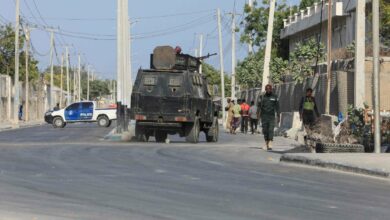 Security forces patrol outside a building which was attacked by suspected Al Shabaab militants in the Somalia's capital Mogadishu