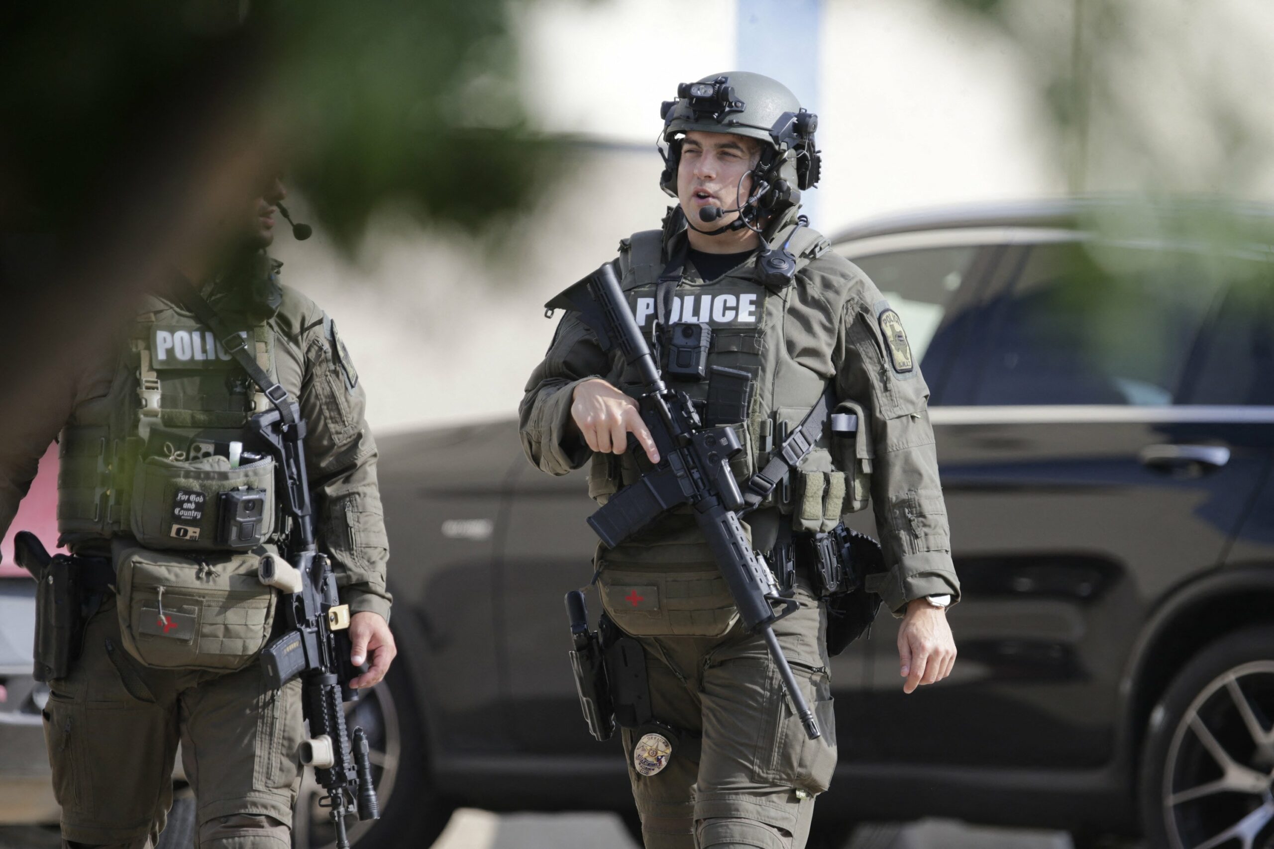 A member of the Allen SWAT team returns to the scene of a shooting in Allen, Texas, May 6, 2023
