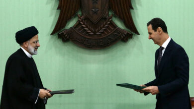 Syria's President Bashar al-Assad (R) and his Iranian counterpart Ebrahim Raisi