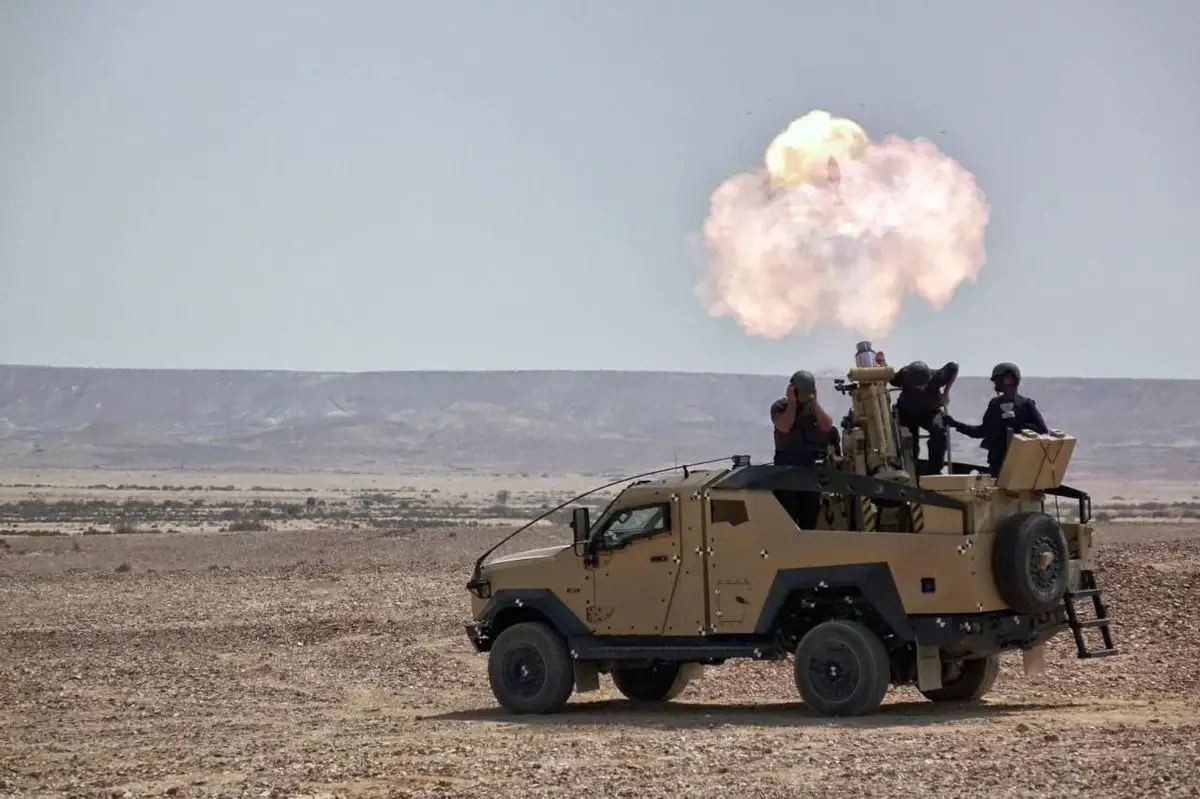 Live firing of 120-mm mortar mounted on armored vehicle.