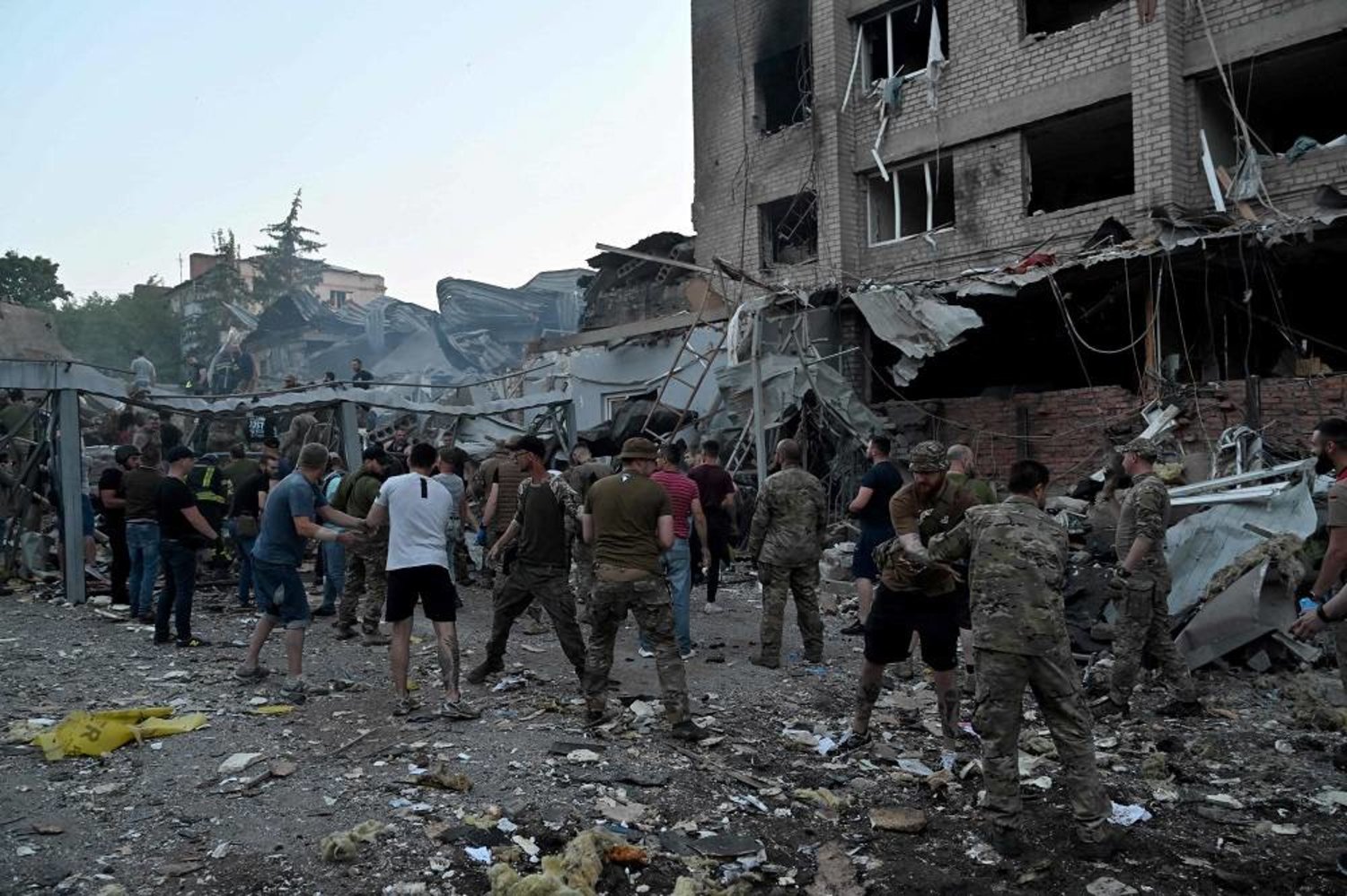 Rescuers and volunteers work to rescue people from under the rubble after a Russian missile strike hit a restaurant and several houses in Kramatorsk, eastern Ukraine, on June 27, 2023