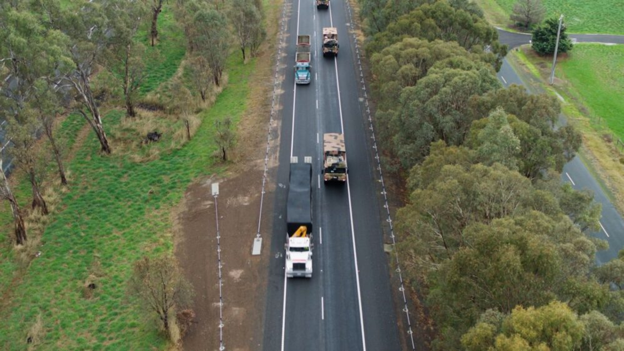 Autonomous Army trucks following a crewed ‘leader’ vehicle on a public road in Victoria. Photo: Australian Ministry of Defence