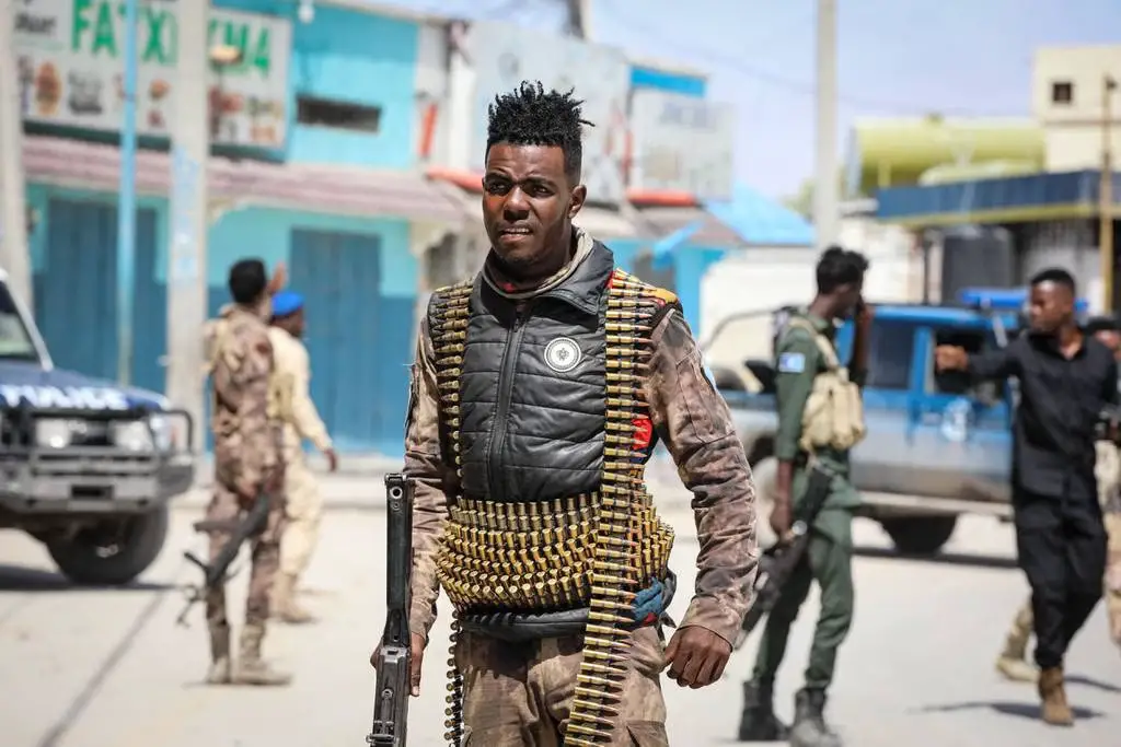 Security officers patrol near the destroyed Hayat Hotel after a deadly 30-hour siege by al-Shabab militants in Mogadishu