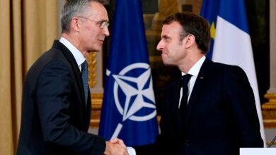 French President Emmanuel Macron and NATO Secretary-General Jens Stoltenberg shake hands
