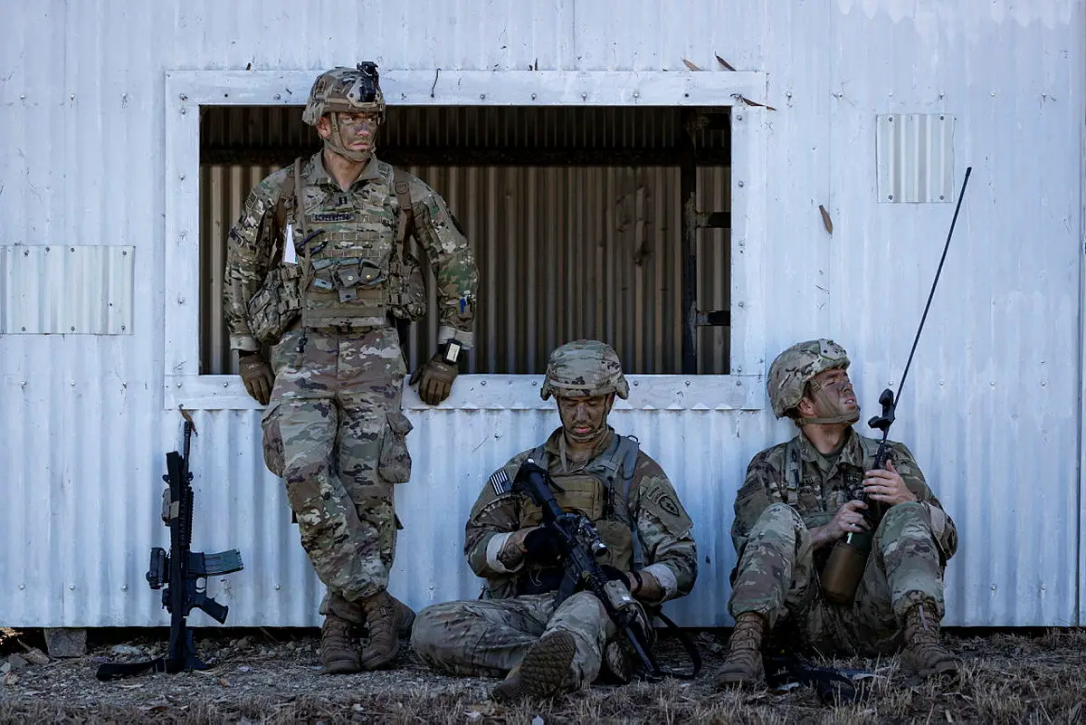US paratroopers rest after conducting clearance of an enemy village during Exercise Talisman Sabre 2021