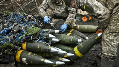 Ukraine soldiers with artillery shells