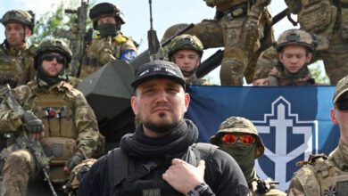 The founder of the Russian Volunteer Corps, Denis Kapustin, flanked by fighters in northern Ukraine, not far from the Russian border