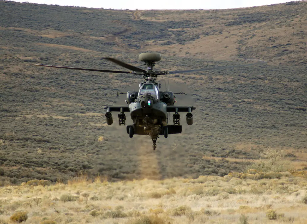 An AH-64 Apache rises from behind a hill during a training exercise at Yakima Training Center. The AH-64E Guardian replaces the AH-64D "Longbow" and integrates more powerful engines, improved rotor blade technology and advanced electronics.