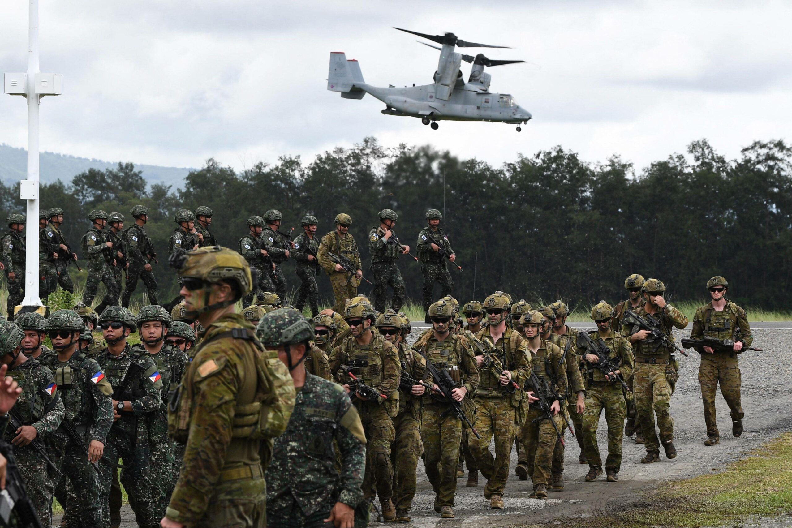 A US V-22 Osprey hovers above Philippine and Australian soldiers at a naval base in San Antonio town in Zambales province.
