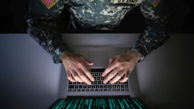 Soldier using laptop cyber