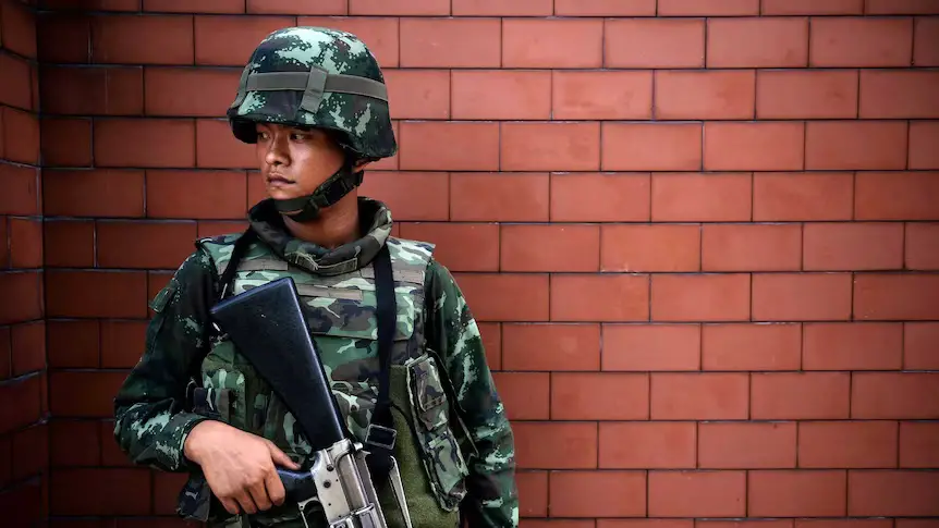 File photo of a Thai soldier standing outside the Government Public Relations Department in Bangkok