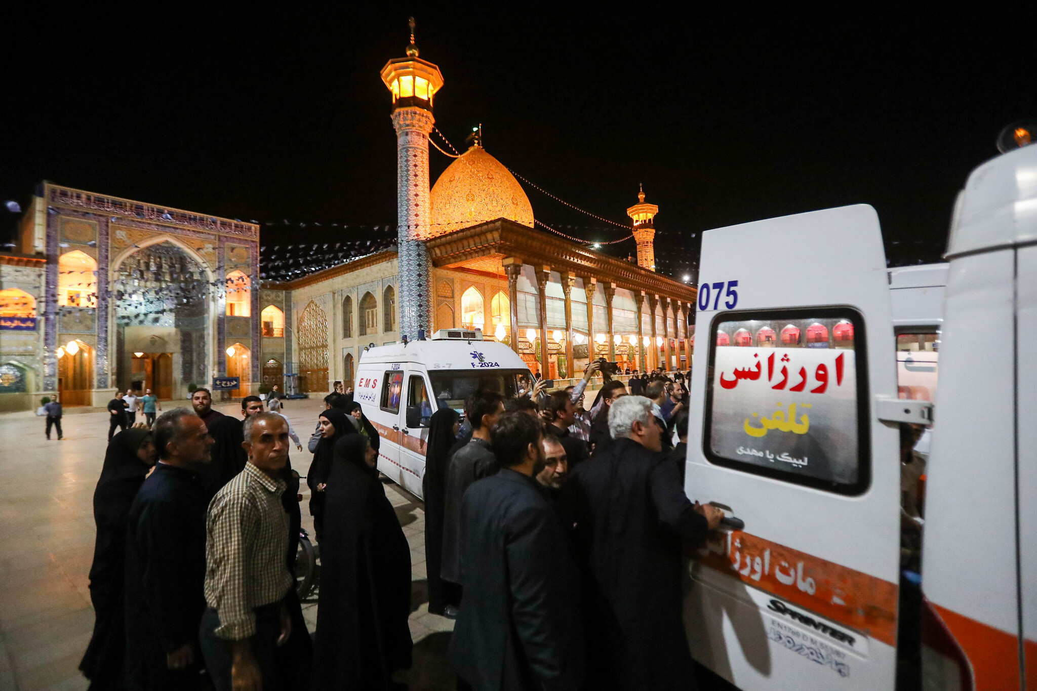 Emergency personnel transport the injured following a shooting attack at Iran's Shah Cheragh mausoleum