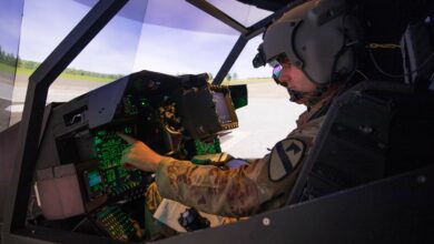 1st Lt. Harrison Ryder, Delta Troop, 7th Bn., 17th Cav. Regt., prepares for flight in an AH-64E Longbow Crew Trainer simulator July 26 at the Flight Simulation Division. (U.S. Army photo by Blair Dupre)