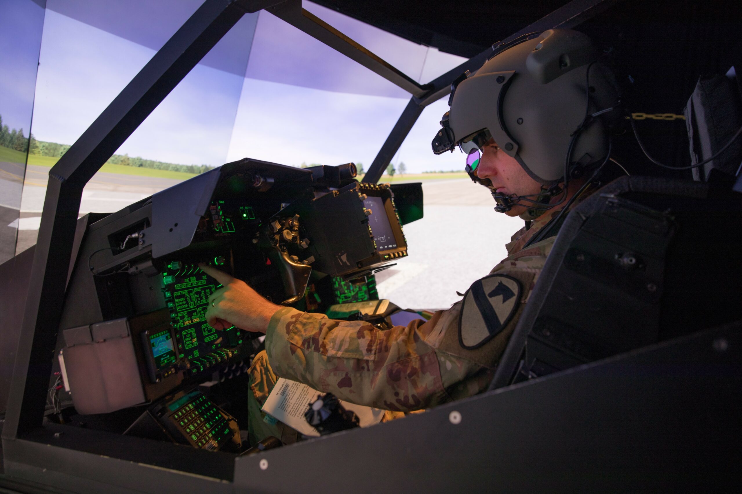 1st Lt. Harrison Ryder, Delta Troop, 7th Bn., 17th Cav. Regt., prepares for flight in an AH-64E Longbow Crew Trainer simulator July 26 at the Flight Simulation Division. (U.S. Army photo by Blair Dupre)