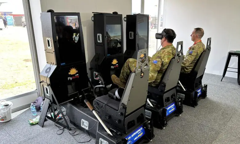 Army officers test out Ryan Aerospace's virtual reality flight simulators at the Australian International Airshow.