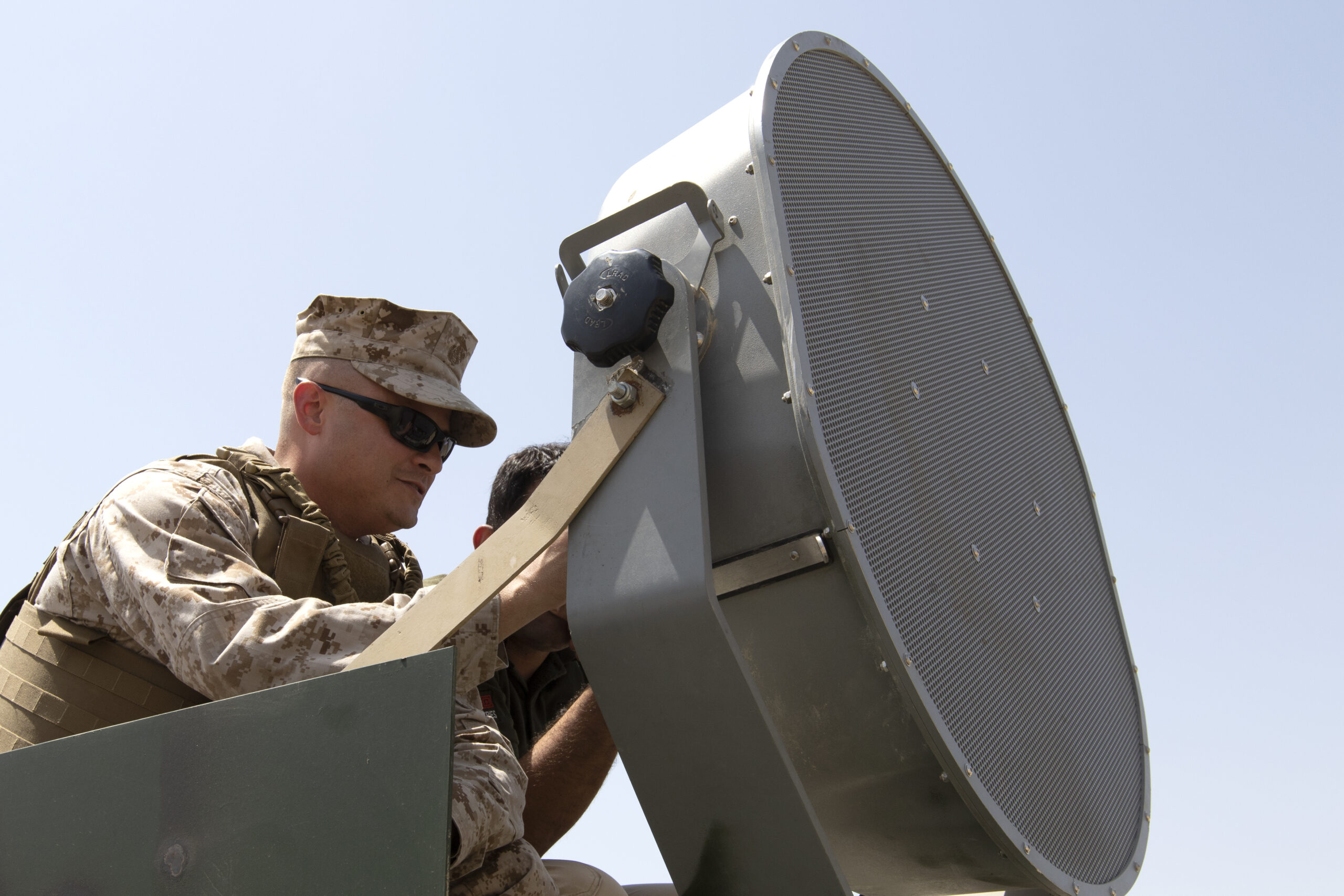 Gunnery Sgt. John Ciupak, an instructor for the VOCALIS training program, prepares a Long Range Acoustic Device at the Iraqi Ground Forces Command Headquarters in Baghdad, July 11, 2018. VOCALIS is an organization that works with the Combined Joint Task Force- Operation Inherent Resolve and tasked with building partnership capacity between the Coalition Forces and Iraqi government. The VOCALIS program is comprised of training packages taught by military and contractor activities, including a train the trainer program. (U.S. Army photo taken by Sgt. Dennis Glass)