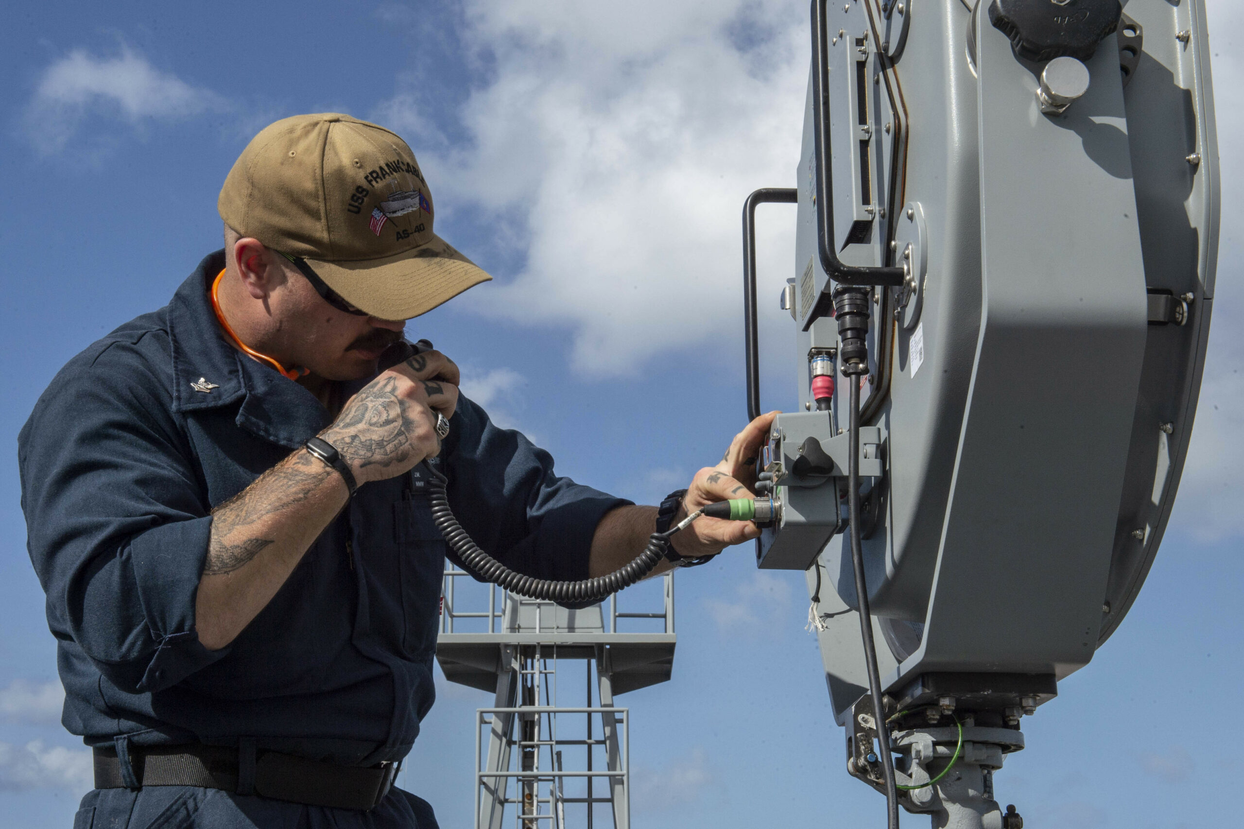 APRA HARBOR, Guam (Dec. 16, 2019) - Torpedoman’s Mate 2nd Class Joseph Sowders tests a long range acoustic device aboard the submarine tender USS Frank Cable (AS 40) as the ship departs to conduct sea trials. Frank Cable, forward deployed to the island of Guam, repairs, rearms, and re-provisions submarines and surface vessels in the Indo-Pacific region. (U.S. Navy photo by Mass Communication Specialist 1st Class Derek Harkins/Released)