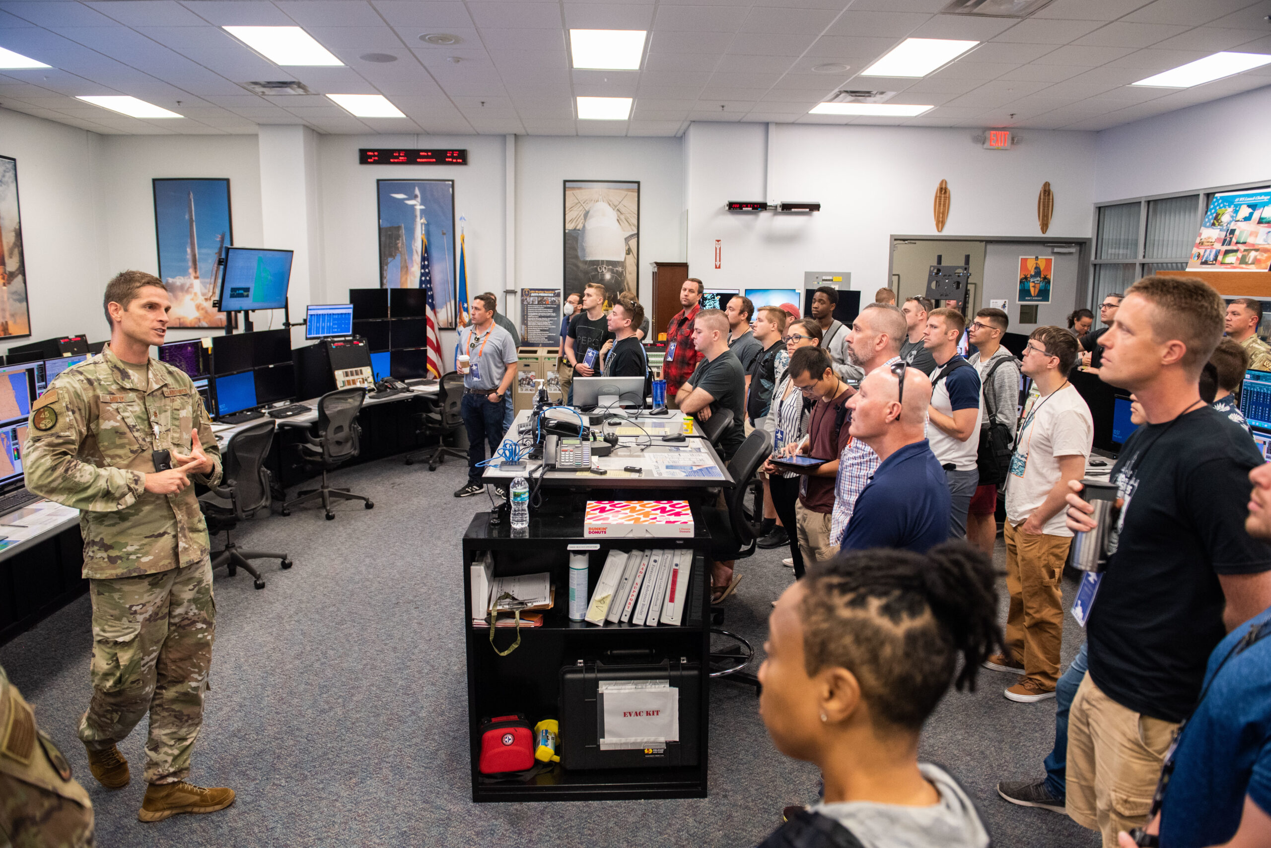 U.S. Air Force Maj. Nathan Motz, 45th Weather Squadron, delivers a mission briefing to participants of the BRAVO Hackathon during a tour the Morrell Operations Center July 19, 2022, at Cape Canaveral Space Force Station, Fla. The event brought engineers, scientists, and coders together from four countries to solve problems with the launch mission. (U.S. Space Force photo by Amanda Inman)
