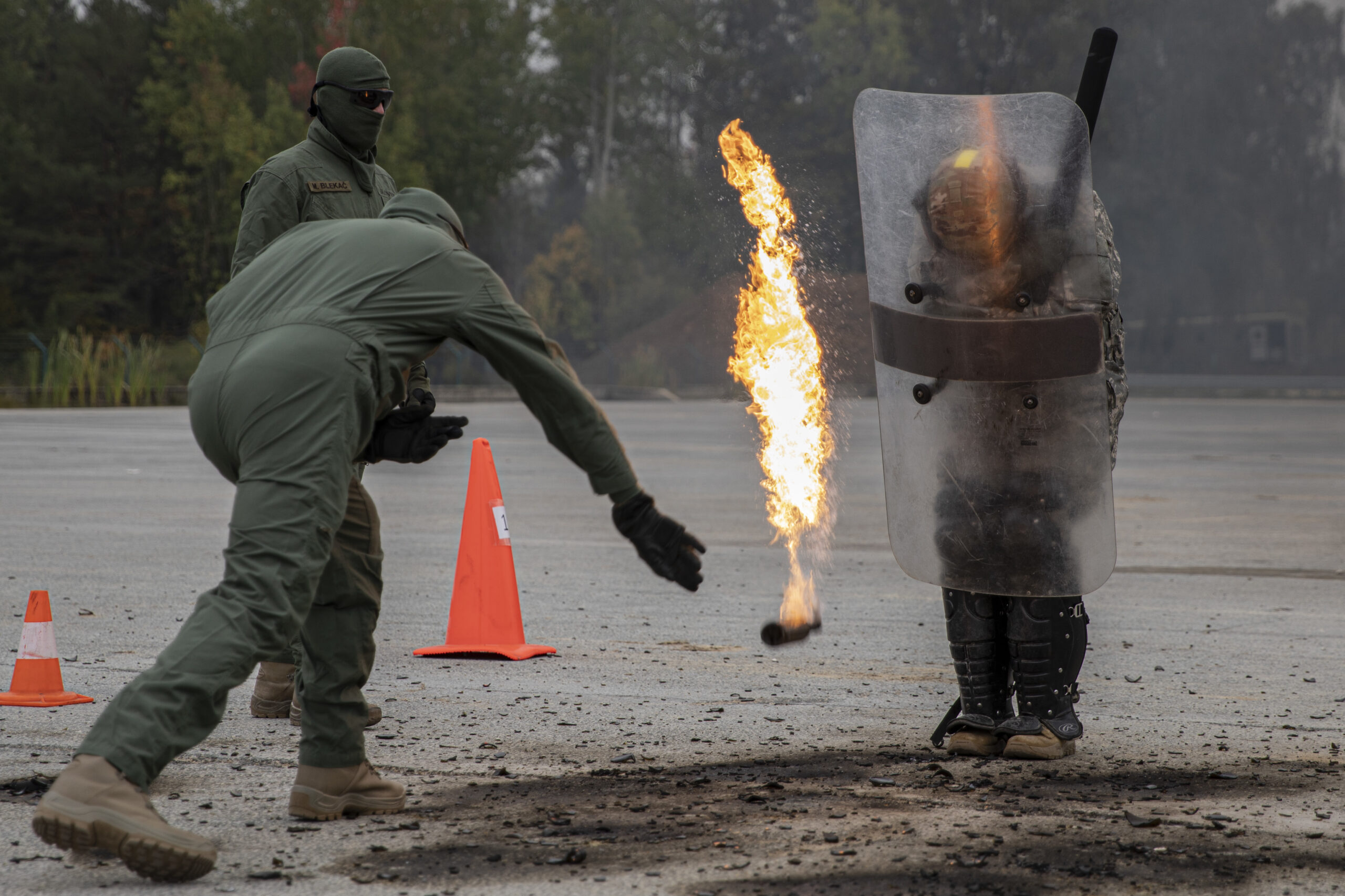 Soldiers of 2-151st Infantry Battalion “Task Force Nighthawk” continue the third day of crowd riot control training as they react to molotov cocktails being thrown at their feet, during a Kosovo Force (KFOR) mission rehearsal exercise, at the Joint Multinational Readiness Center, in Hohenfels, Germany, Oct. 8, 2022. KFOR 31 is a multinational training event conducted to prepare units for their deployment to the Kosovo Regional Command East. (U.S. Army photos by Staff Sgt. Anna Pongo)