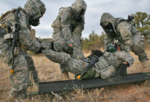 Soldiers with 1st Squadron, 10th Cavalry Regiment, 2nd Brigade Combat Team, 4th Infantry Division, move an injured soldier onto a litter during the chemical, biological, radiological and nuclear testing phase during the squadron's annual spur ride, Nov. 1, 2012. The tasks the spur candidates were required to complete included a physical fitness test, a written test, vehicle identification, an obstacle course and a land navigation course carrying a 40-65 pound rucksack and at each point on the course they were tested on basic soldiering skills. (U.S. Army photo by Staff Sgt. Ruth Pagan, 2nd BCT PAO, 4th Inf. Div.)