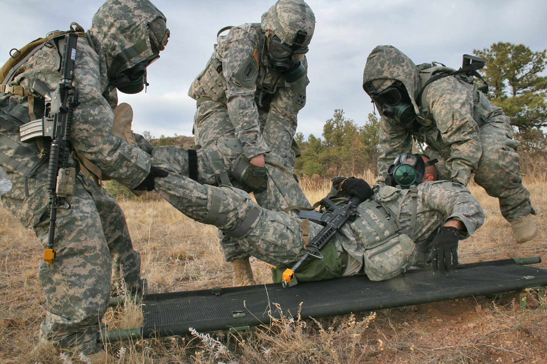 Soldiers with 1st Squadron, 10th Cavalry Regiment, 2nd Brigade Combat Team, 4th Infantry Division, move an injured soldier onto a litter during the chemical, biological, radiological and nuclear testing phase during the squadron's annual spur ride, Nov. 1, 2012. The tasks the spur candidates were required to complete included a physical fitness test, a written test, vehicle identification, an obstacle course and a land navigation course carrying a 40-65 pound rucksack and at each point on the course they were tested on basic soldiering skills. (U.S. Army photo by Staff Sgt. Ruth Pagan, 2nd BCT PAO, 4th Inf. Div.)