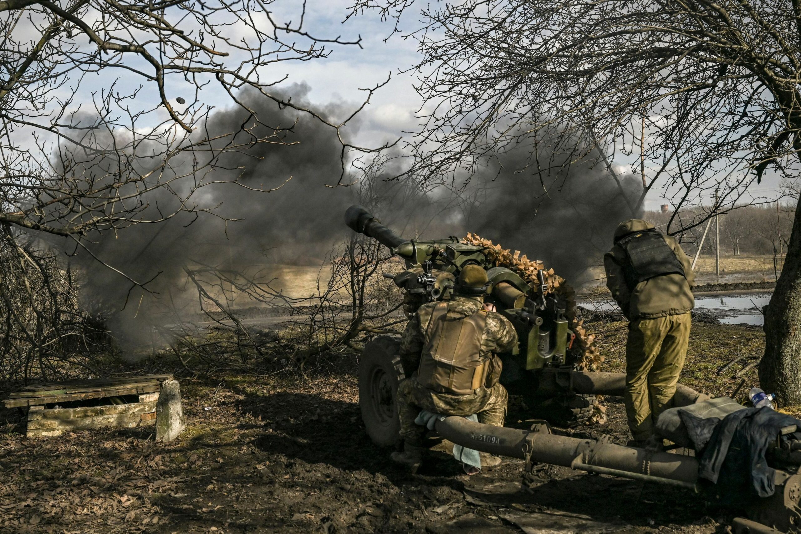 Ukrainian servicemen fire a 105mm Howitzer towards Russian positions near the city of Bakhmut