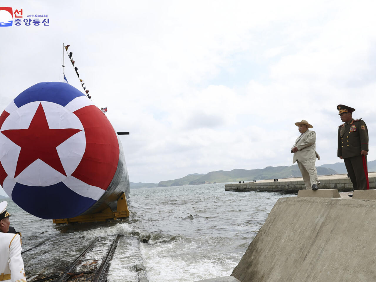 North Korean leader Kim Jong Un next to the country's new submarine