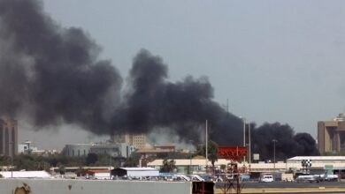 Heavy smoke bellows above buildings in the vicinity of the Khartoum airport, in Khartoum, Sudan