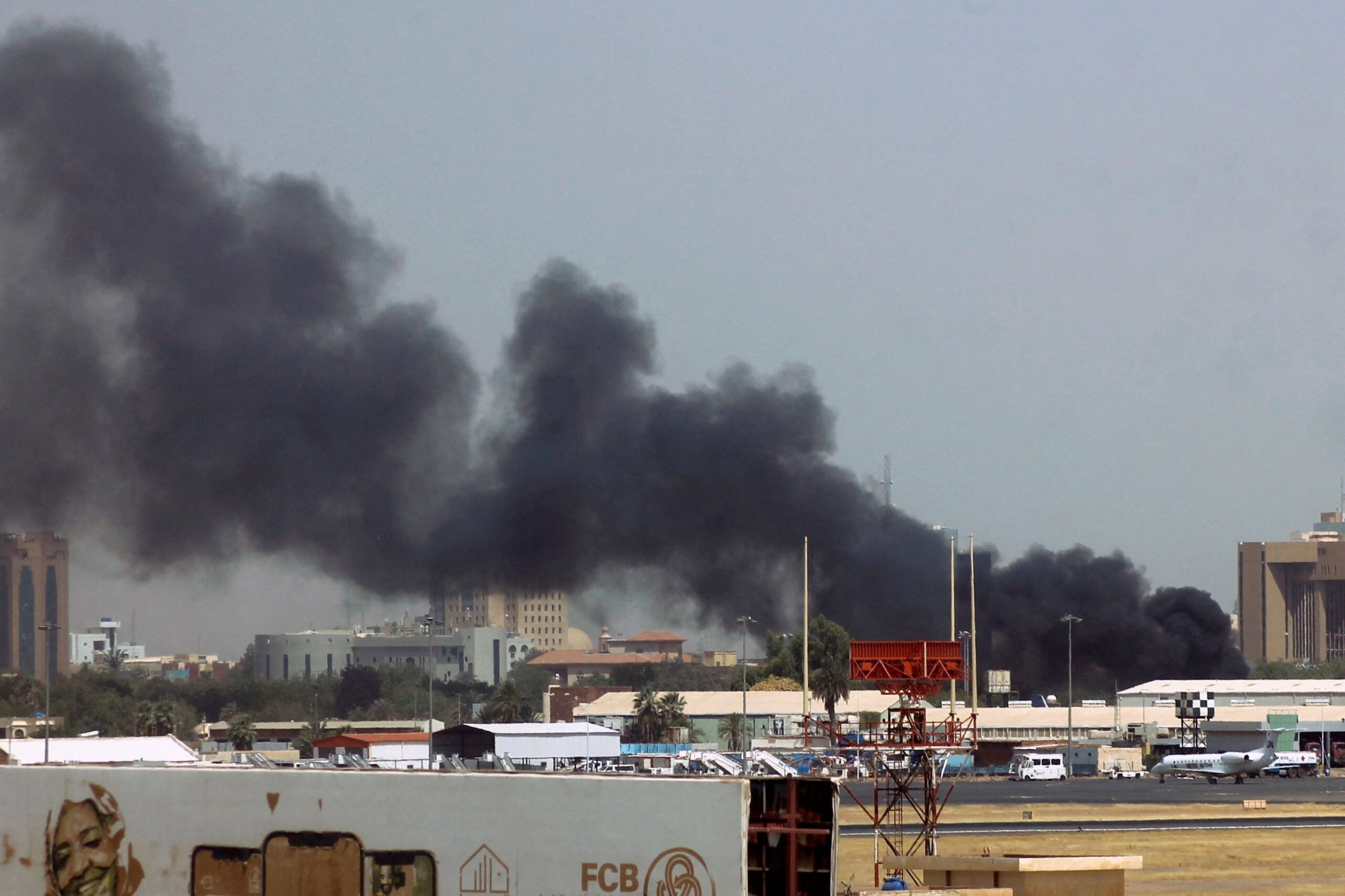 Heavy smoke bellows above buildings in the vicinity of the Khartoum airport, in Khartoum, Sudan