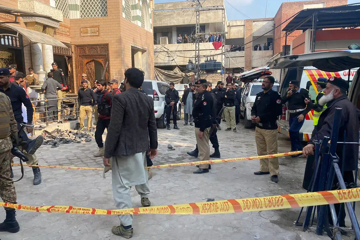 Security personnel cordon off the site of a mosque blast inside the provincial police headquarters in Peshawar