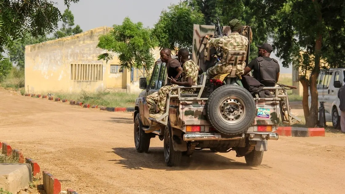 Nigerian Army soldiers are seen driving on a military vehicle in Ngamdu, Nigeria