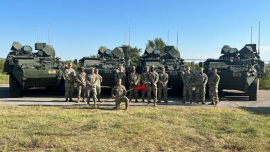 Soldiers of the 4th Battalion, 60th Air Defense Artillery Regiment are positioned alongside four Directed Energy Maneuver-Short Range Air Defense (DE M-SHORAD) prototype systems. (4th Battalion, 60th Air Defense Artillery Regiment )